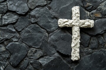 white cross on black stone background with copy space 