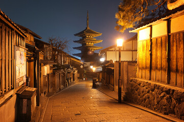 Beautiful night view of Yasaka Pagoda (Hōkanji Temple) in Kyoto, Japan, with warm street lights...