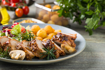 Pork tenderloin, served with mushrooms and peppers.