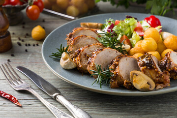 Pork tenderloin, served with mushrooms and peppers.