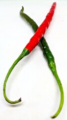 Red and green hot chili peppers on white background