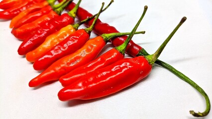 Cayenne pepper arranged on white background
