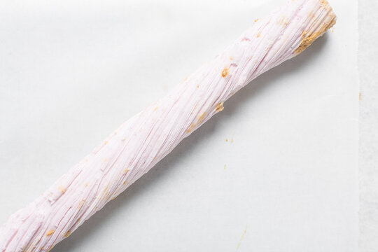 Overhead view of Nigerian Balewa candy, top view of hausa alewa candy on a white background, pulled hard sugar candy on a white countertop