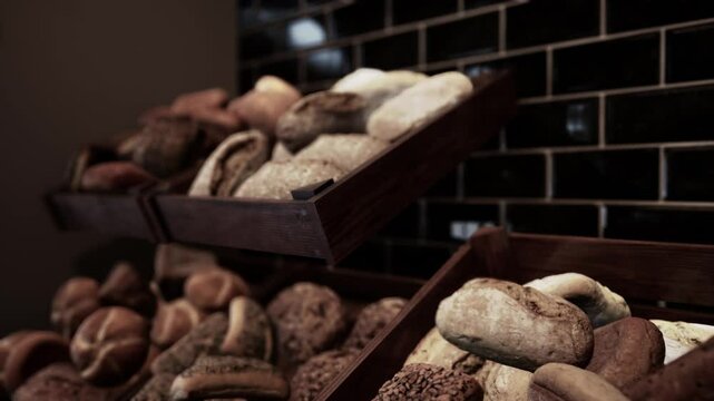 A collection of different types and varieties of bread neatly arranged and stored in a box on store shelves.