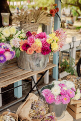 Chrysanthemums and dahlias in a metal pot outdoors