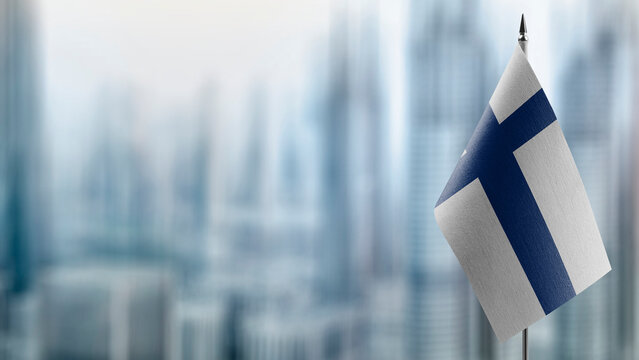 Small flags of the Finland on an abstract blurry background