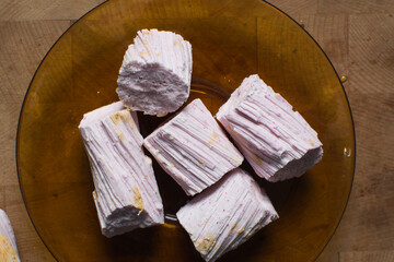 Overhead view of Nigerian Balewa candy, top view of hausa alewa candy on a brown plate, pulled hard sugar candy on a plate	
