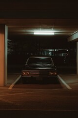 Dark Vintage Car Parked Under Light for Travel, Insurance Adverts or Cinematic Views