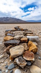 Circle of stones on desert plain under blue sky and white clouds