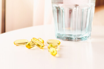 Capsules of Golden fish oil. Nutritional supplements for good health on a white background. Supplementary feeding. Omega-3. Concept of health and healthy nutrition.