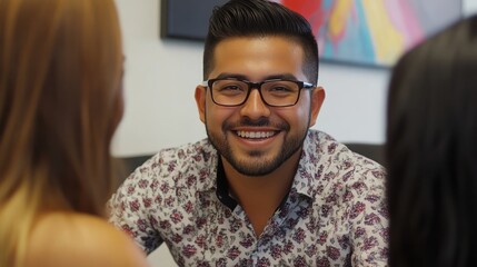 Smiling man in floral shirt engaging with friends