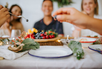 Christmas table setting with fresh fruit platter and happy family in the background