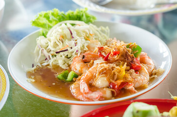 Shrimp dish with vegetables and sauce on a plate