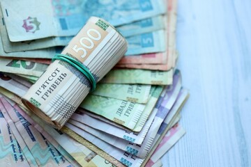 Big amount of different ukrainian hryvnia currency money bills on wooden background