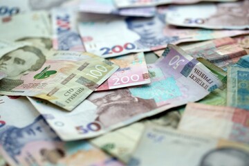 Big amount of different ukrainian hryvnia currency money bills in pile