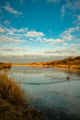 Beautiful nature on the lake ,sunrise from the hills, landscape photoshoot of beautiful red and orange sunrise , sky and clouds , reflections on water . Breathtaking sunrise , place of silence 