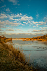 Beautiful nature on the lake ,sunrise from the hills, landscape photoshoot of beautiful red and orange sunrise , sky and clouds , reflections on water . Breathtaking sunrise , place of silence 