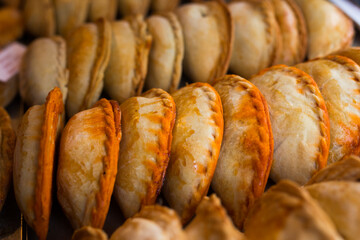 Freshly baked empanadas with different fillings for sale