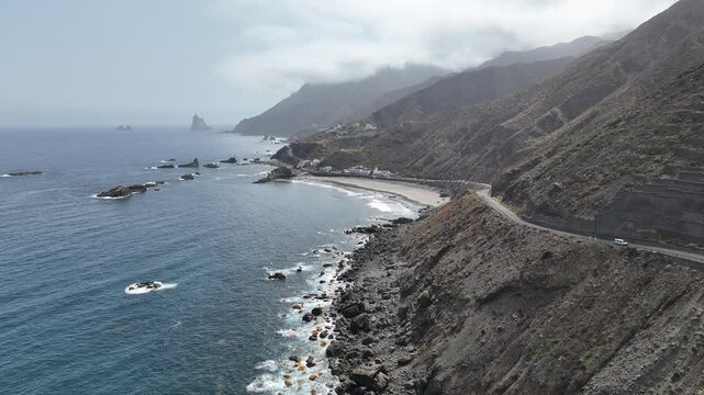 Drone video of a cliff with a road by the ocean near Tenerife