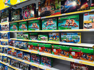 Naklejka premium Lviv, Ukraine - February 16, 2025: Colorful display of toy building sets in a store with Lego themes