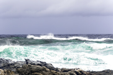 Fototapeta premium Large Indian Ocean waves and rocky coastline in Tsitsikamma, Garden Route National Park, Eastern Cape. South Africa 