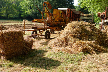 Vintage Threshing Machine with Hay Bales