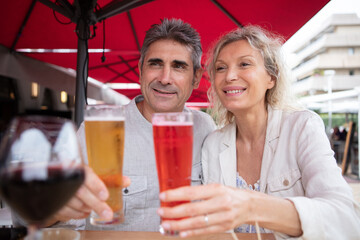 happy seniors talking and smiling during dinner