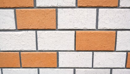 Obraz premium A close-up photograph of a decorative brick wall with alternating orange and white bricks.