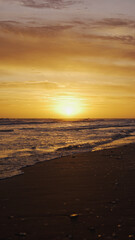Fototapeta premium Sun coming down at dusk with amazing ocean view by the coast