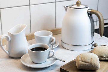 Breakfast on the kitchen table with fresh bread and coffee. High quality photo
