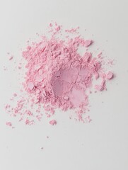 Fototapeta premium Soft pink powder scattered on a white surface creates an artistic display showcasing color and texture