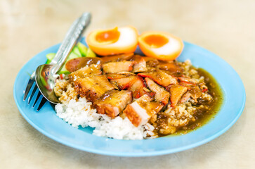 Barbecued red pork in sauce and crispy pork with rice, Thailand