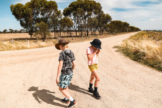 Kids exploring dirt road during times of drought in rural Australia