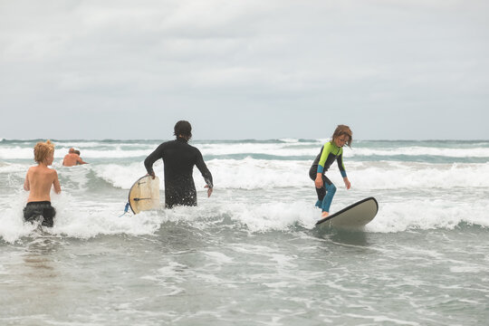 Young boy learning to surf in Portland Victoria