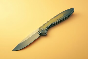 Fototapeta premium Folding pocket knife with gray and yellow handle on tan