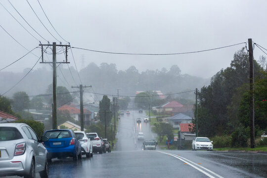 Rainy stormy day with vehicles driving on slippery wet road in Newcastle