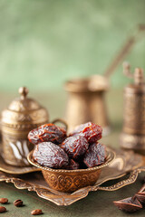 Cup of coffee, armudu glass and dry dates  for iftar time. Islamic religion and ramadan concept.