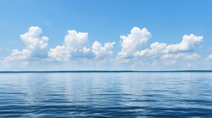 Obraz premium Tranquil Blue Ocean with Fluffy White Clouds Under Bright Clear Sky on a Sunny Day