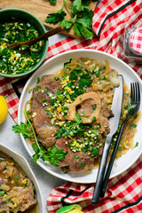 Traditional Italian Ossobuco with Gremolata and  polenta in a bowl.style huggr