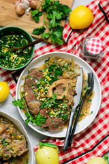 Traditional Italian Ossobuco with Gremolata and  polenta in a bowl.style huggr