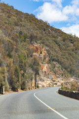 rock fall prevention metal net two lane rural Tasman highway road