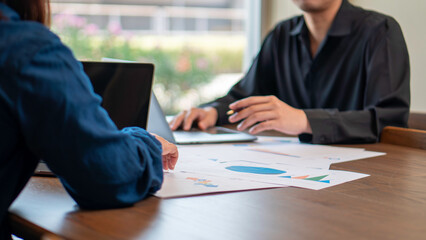 business collaboration, financial analysis, and teamwork, professionals reviewing financial reports and discussing data. The workspace, charts, and strategic documents, a corporate and analytical