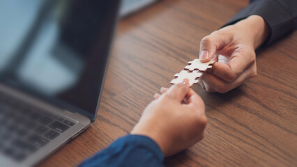 teamwork, problem and collaboration, featuring two hands connecting puzzle pieces surface. the idea of partnership, strategy, and finding the right fit in both business and personal relationships.