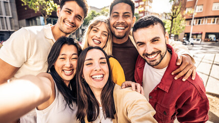 Multicultural cheerful friends taking selfie pic with smart mobile phone device - Youth community...