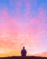 Obraz premium Vibrant Sunset Reflection Meditative Silhouette on Hilltop with Colorful Sky - Spiritual Content for Mindfulness Campaigns and Inspirational Wellbeing Promotion