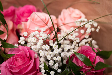 Romantic bouquet of pink and peach roses accented with baby's breath. Perfect for anniversaries,...