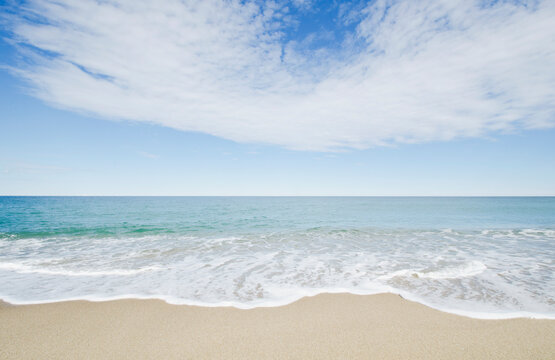Ocean waves on sandy beach
