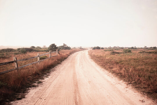 Dirt road crossing grassy fields leading to Cisco Beach