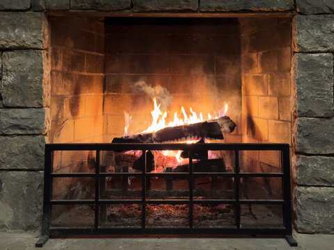 Wood burning in old stone fireplace