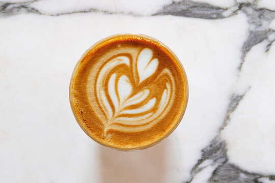 Overhead view of coffee&nbsp;with foam latte art on marble surface